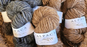 Skeins of grey and brown alpaca yarn.