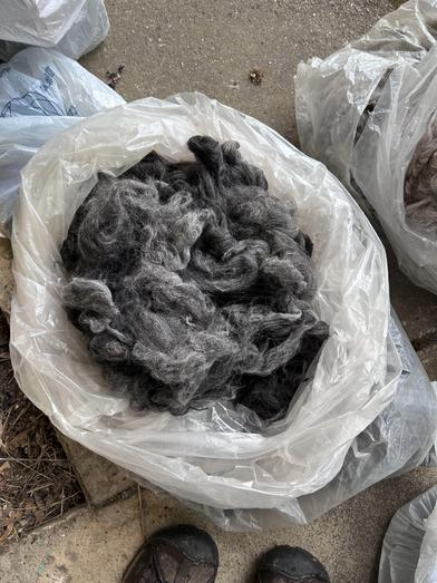 grey alpaca fleece in a bag
