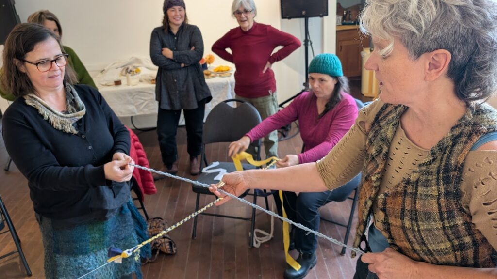 two people tension each other making cordage